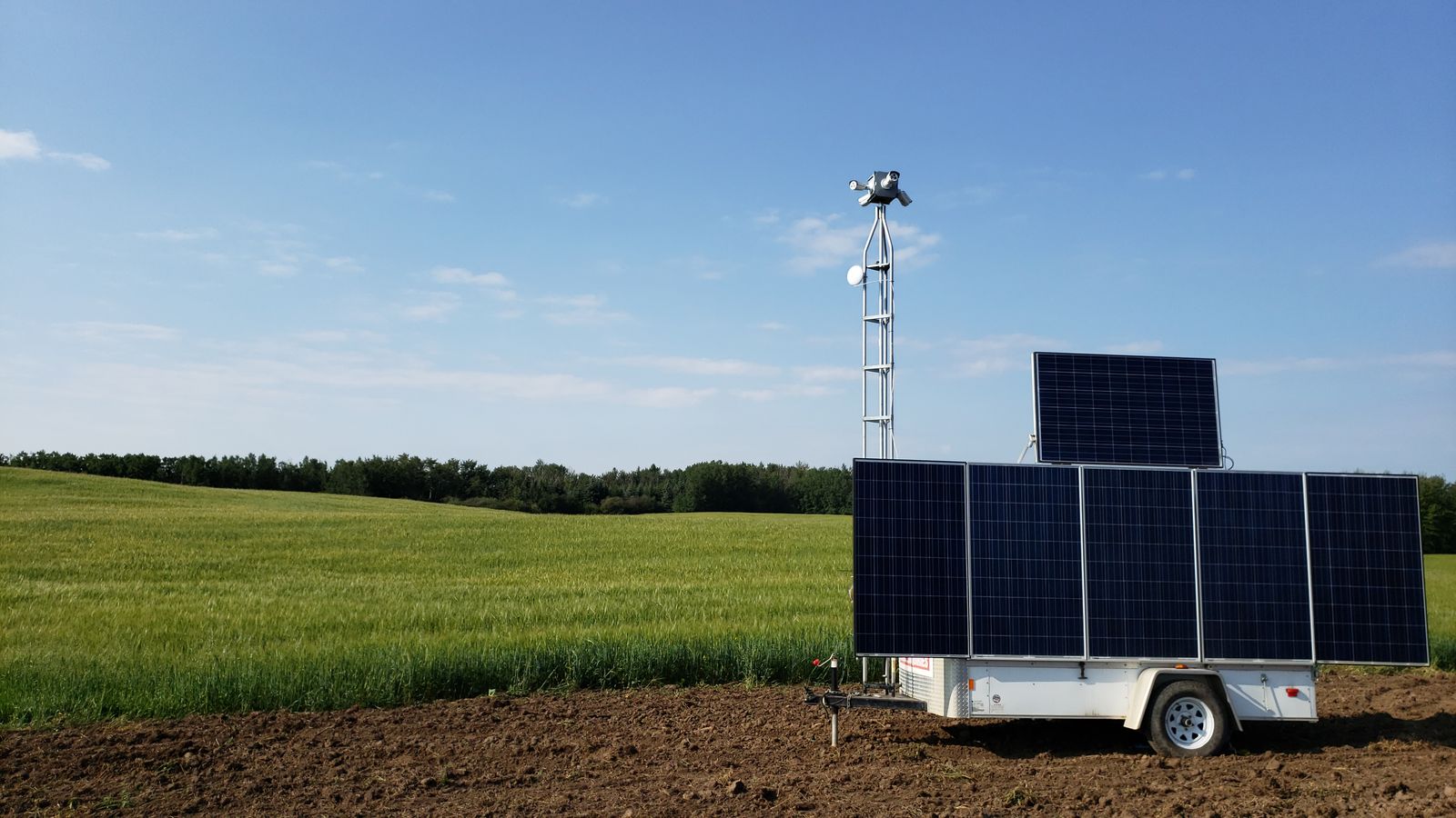 Gatekeeper solar-powered remote video surveillance trailer with camera mast guarding an Alberta job site